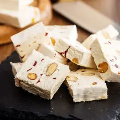 Délicieux nougat blanc aux amandes et fruits secs, parfait pour une recette maison.