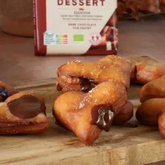 Des cœurs gourmands de beignet au chocolat, certains saupoudrés de sucre, d'autres généreusement garnis de chocolat fondant.