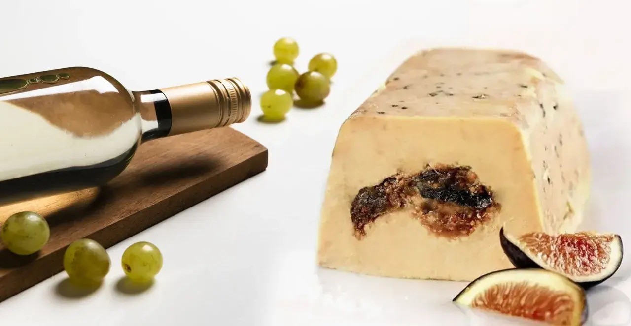 Bouteille de vin blanc, raisins et foie gras aux figues, un accord parfait pour le saumon.